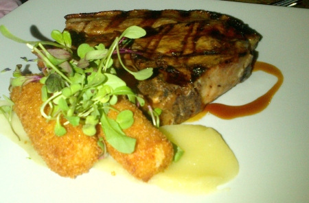 Acorn-fed pork cutlet, served with quince paste, scented pomme croquettes, apple puree and a brandy butter glaze